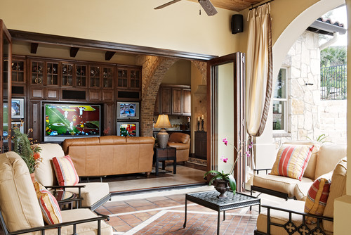 some outdoor living rooms have a glass wall that opens to merge indoor & outdoor space